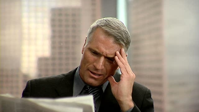 upset man with newspaper